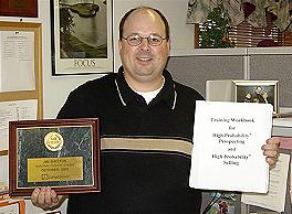 Photo of Jim Shelton holding his new award plaque.